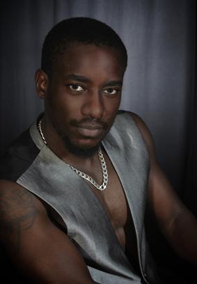 A black man in a vest